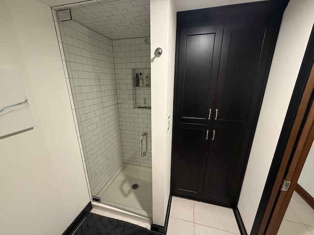 bathroom featuring baseboards and a stall shower