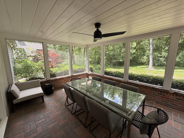 sunroom with outdoor dining space, plenty of natural light, and ceiling fan