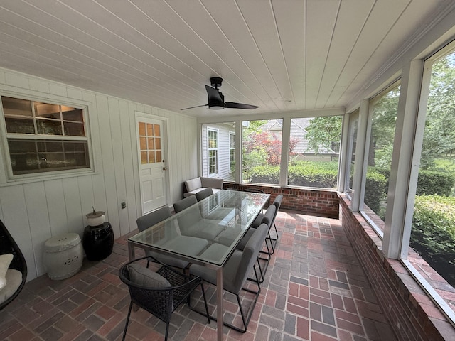 sunroom featuring ceiling fan and outdoor dining space