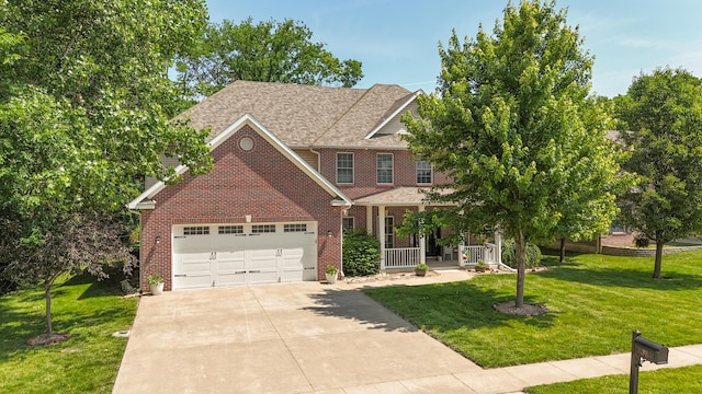 901 Fox Run, Moberly, MO 65270 - view of front of house featuring brick siding, a garage, a porch, and a front yard