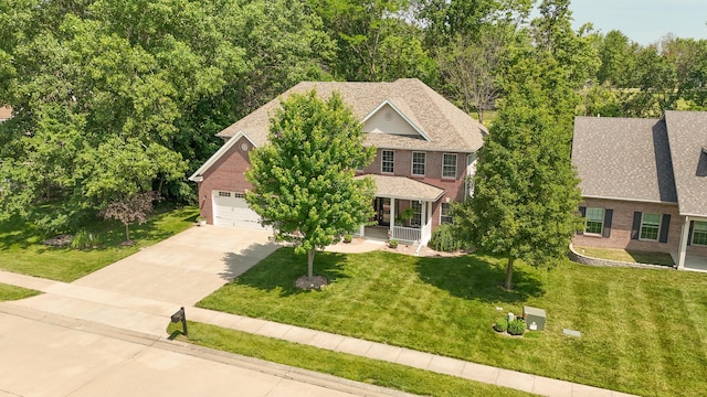 901 Fox Run, Moberly, MO 65270 - colonial inspired home featuring brick siding, concrete driveway, and a front yard
