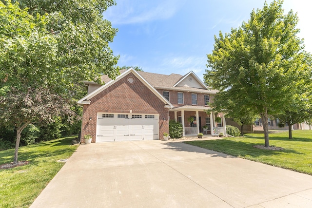 901 Fox Run, Moberly, MO 65270 - view of front of property with a porch, brick siding, a garage, and a front yard