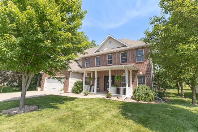 901 Fox Run, Moberly, MO 65270 - view of front facade with a porch, brick siding, driveway, a front yard, and a garage
