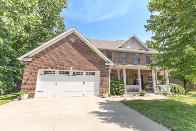 901 Fox Run, Moberly, MO 65270 - view of front of property featuring brick siding, a porch, an attached garage, driveway, and a front yard