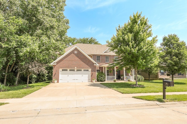 901 Fox Run, Moberly, MO 65270 - view of front of home with a front yard, brick siding, concrete driveway, a garage, and covered porch