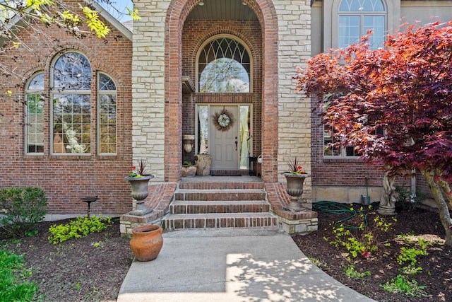 view of exterior entry featuring brick siding