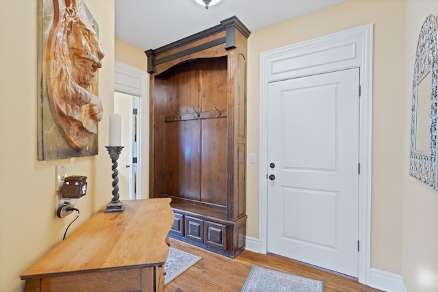 interior space with baseboards and light wood-style floors