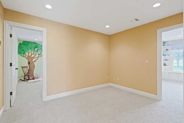 spare room featuring baseboards, carpet flooring, visible vents, and recessed lighting