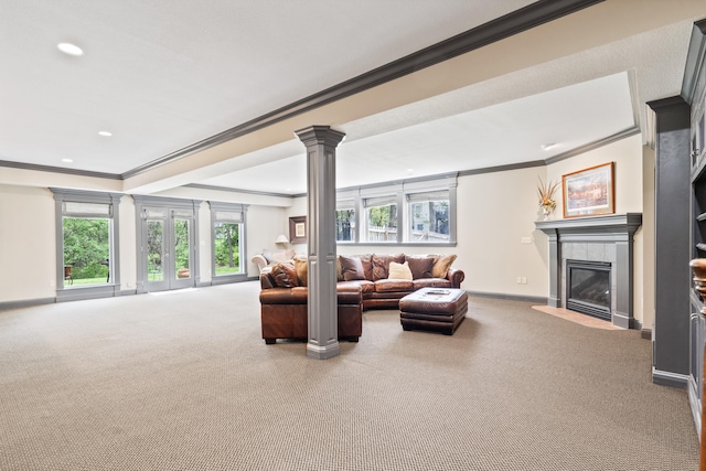carpeted living area featuring a tiled fireplace, decorative columns, baseboards, recessed lighting, and crown molding