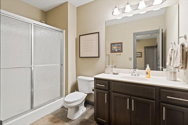 full bathroom featuring a shower stall, toilet, vanity, and tile patterned floors