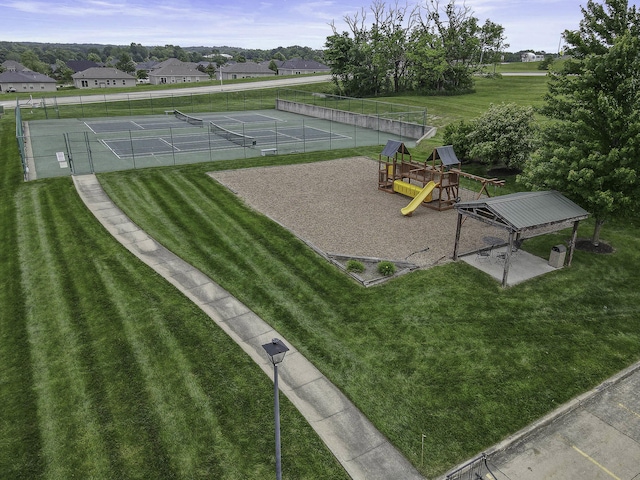 exterior space featuring fence, a lawn, playground community, and a tennis court