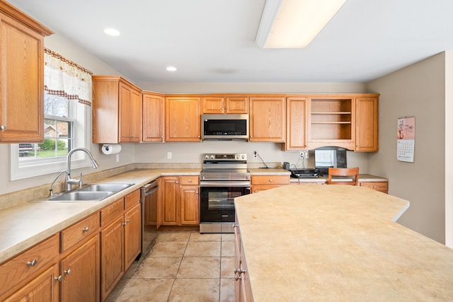 kitchen featuring open shelves, a sink, light countertops, appliances with stainless steel finishes, and recessed lighting