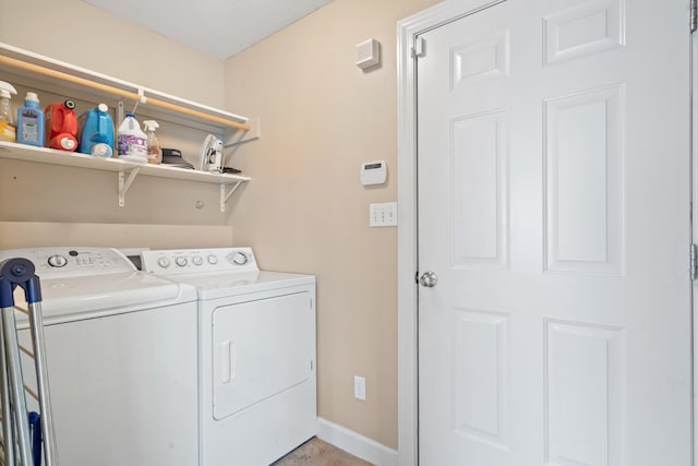 laundry area with washer and dryer, baseboards, and laundry area