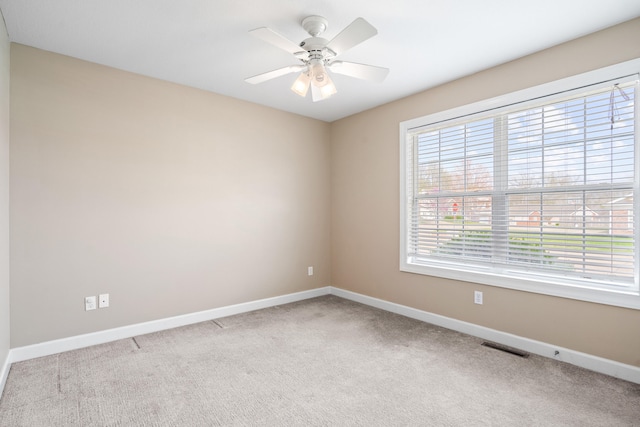 empty room featuring visible vents, baseboards, carpet, and ceiling fan