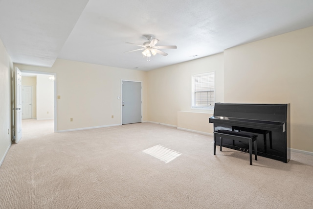 sitting room featuring light colored carpet, ceiling fan, and baseboards
