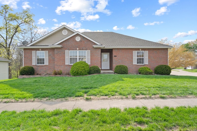 single story home featuring a front lawn, brick siding, and roof with shingles
