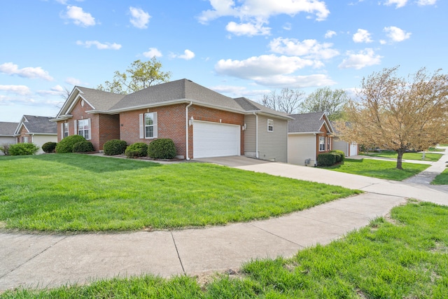 single story home featuring brick siding, an attached garage, a front yard, and concrete driveway