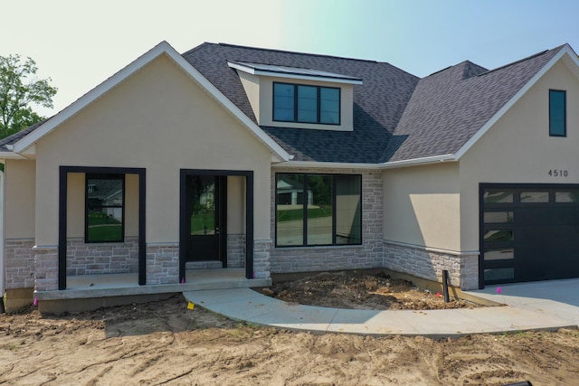 4510 Stonington Ct, Columbia, MO 65203 - view of front facade with stucco siding, stone siding, an attached garage, roof with shingles, and covered porch