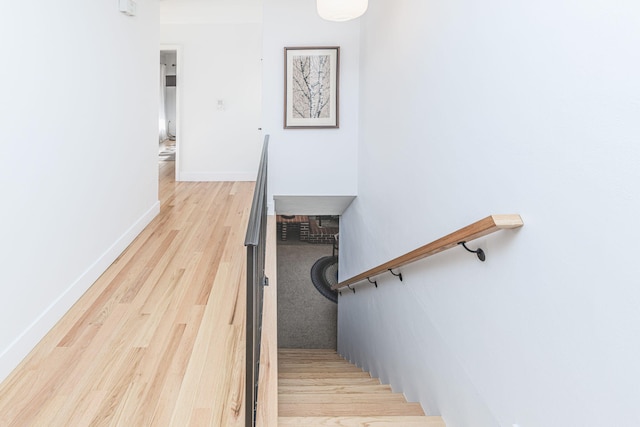 stairway with baseboards and wood finished floors
