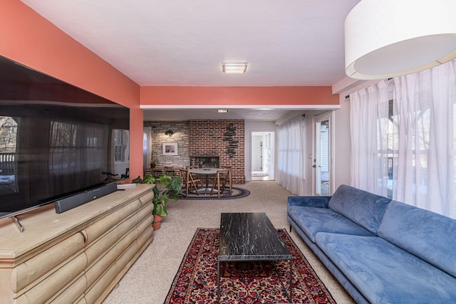living area with carpet and a brick fireplace