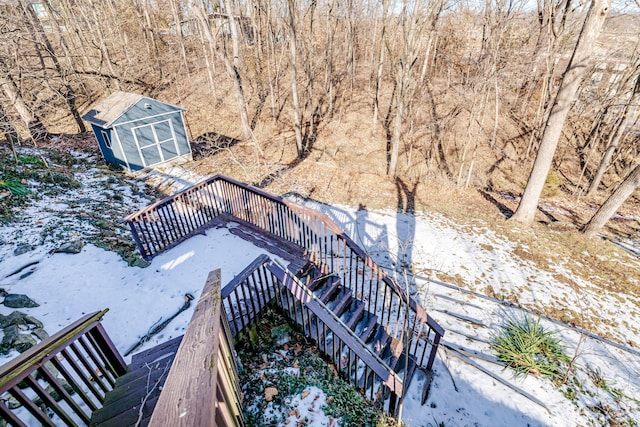 exterior space with an outdoor structure, a storage unit, stairs, and a deck