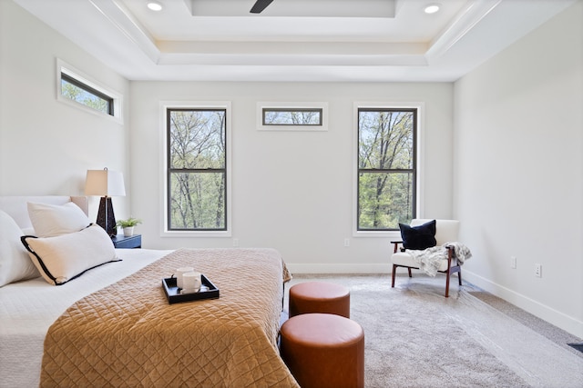 bedroom with recessed lighting, a tray ceiling, baseboards, and carpet