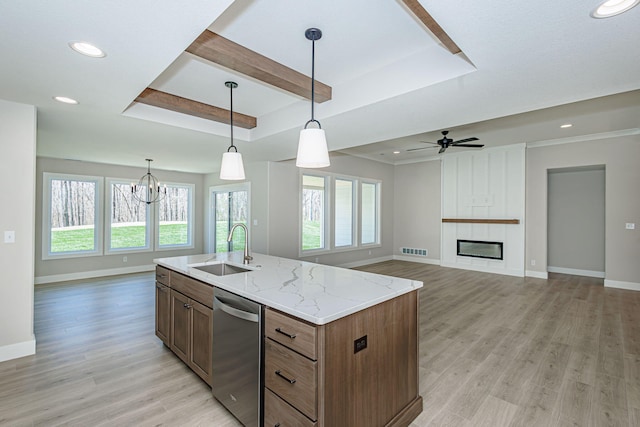 709 Sagemoor Dr, Columbia, MO 65201 - kitchen with light wood finished floors, visible vents, stainless steel dishwasher, a sink, and baseboards