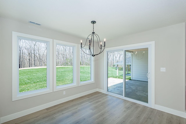 709 Sagemoor Dr, Columbia, MO 65201 - unfurnished dining area featuring a chandelier, wood finished floors, visible vents, and baseboards