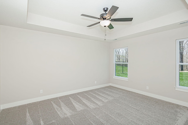 709 Sagemoor Dr, Columbia, MO 65201 - spare room with a raised ceiling, visible vents, a ceiling fan, light carpet, and baseboards