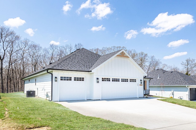 709 Sagemoor Dr, Columbia, MO 65201 - view of side of property with driveway, an attached garage, a shingled roof, board and batten siding, and a yard