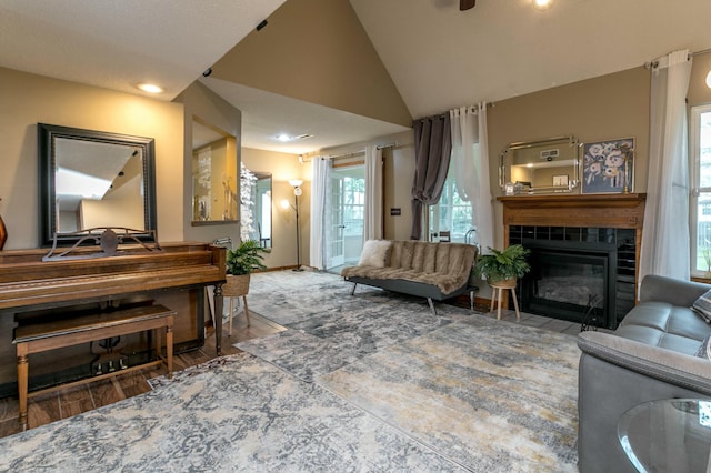3701 Churchill Dr, Columbia, MO 65201 - living room featuring lofted ceiling, baseboards, a tile fireplace, recessed lighting, and wood finished floors