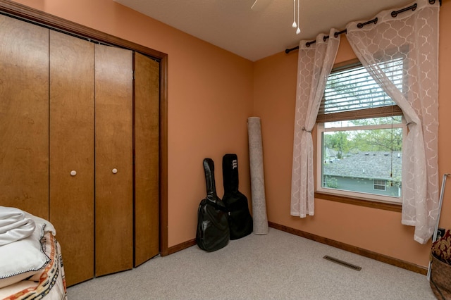 3701 Churchill Dr, Columbia, MO 65201 - carpeted bedroom with visible vents, ceiling fan, baseboards, and a closet