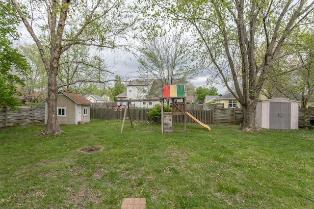 3701 Churchill Dr, Columbia, MO 65201 - view of yard featuring an outdoor structure, a storage shed, a playground, and a fenced backyard