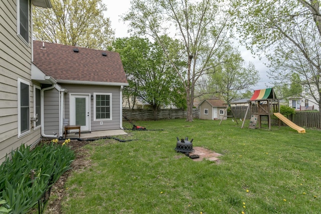 3701 Churchill Dr, Columbia, MO 65201 - view of yard featuring a storage unit, a fenced backyard, a playground, and an outdoor structure