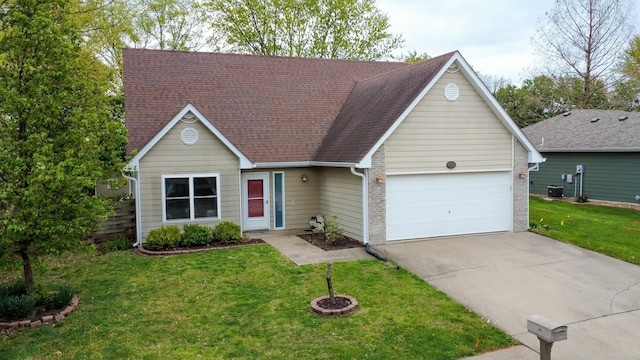 3701 Churchill Dr, Columbia, MO 65201 - view of front of home featuring driveway, a front yard, brick siding, and a garage