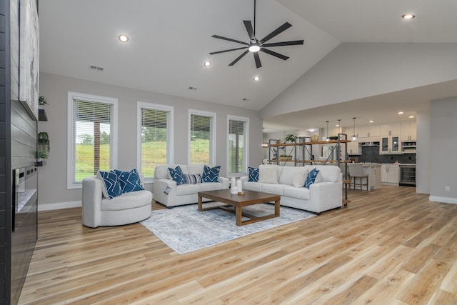 6301 Crooked Switch Ct, Columbia, MO 65201 - living area with ceiling fan, a large fireplace, light wood finished floors, high vaulted ceiling, and recessed lighting