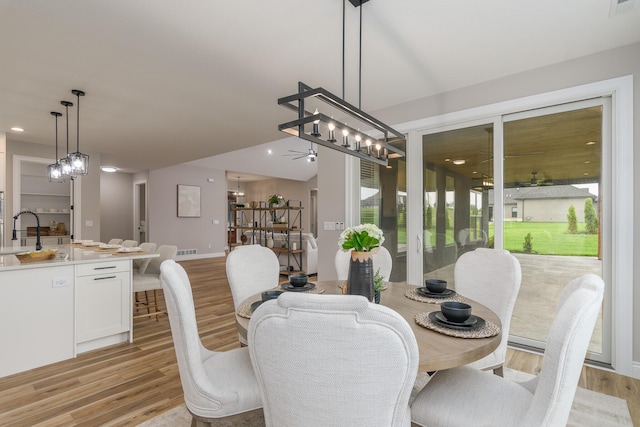 6301 Crooked Switch Ct, Columbia, MO 65201 - dining area with light wood-type flooring, a ceiling fan, a chandelier, recessed lighting, and baseboards