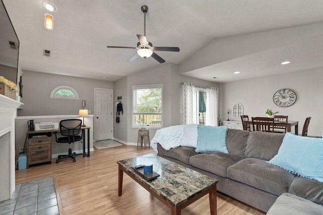 living room with plenty of natural light, ceiling fan, light wood-type flooring, and visible vents