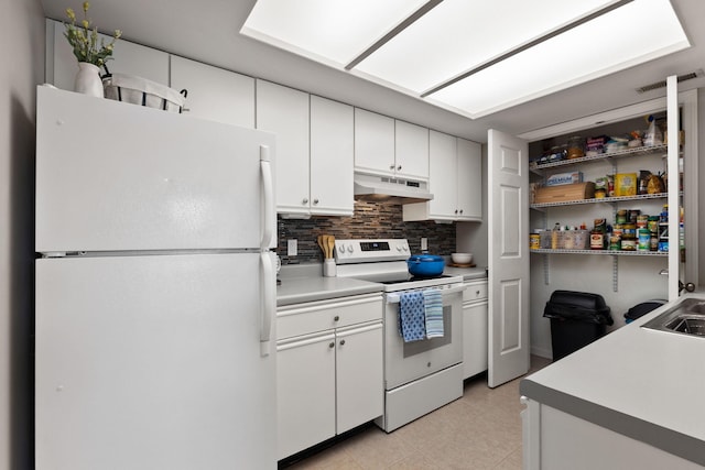 kitchen featuring white appliances, light countertops, white cabinetry, under cabinet range hood, and tasteful backsplash
