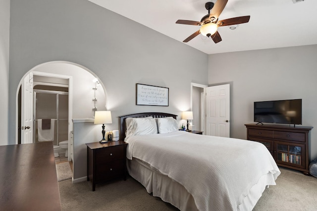 bedroom with arched walkways, carpet, ceiling fan, and lofted ceiling