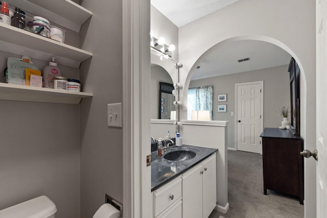 bathroom with visible vents, toilet, and vanity