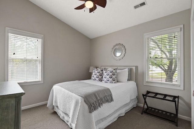 bedroom featuring vaulted ceiling, visible vents, multiple windows, and carpet