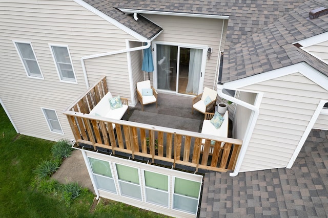 back of property with roof with shingles