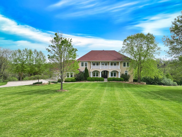 8130 S Country Aire Ln, Columbia, MO 65203 - view of front facade featuring a balcony, a front lawn, and stucco siding
