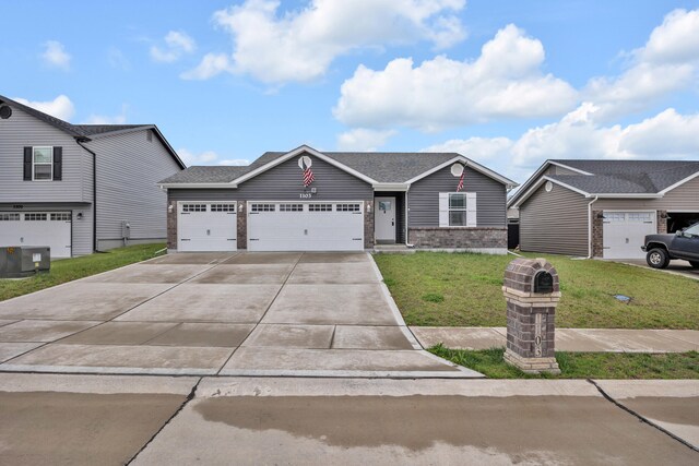 1103 Baseball Dr, Foristell, MO 63384 - view of front facade with an attached garage, a front lawn, brick siding, central AC unit, and concrete driveway
