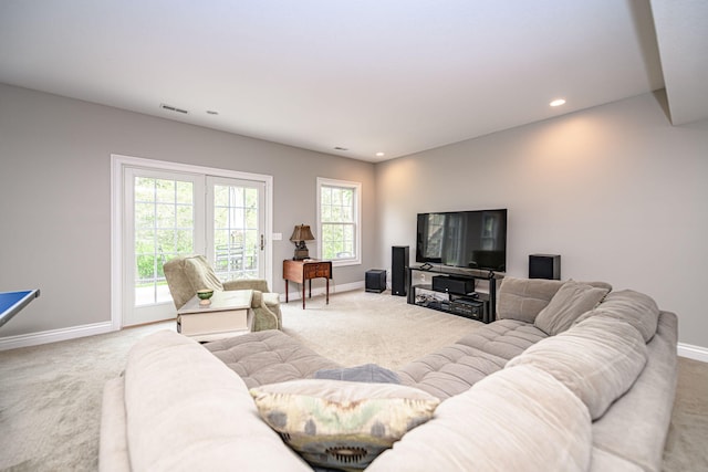 living area with visible vents, carpet flooring, and baseboards