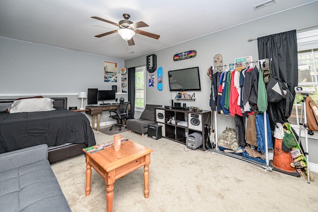 carpeted bedroom featuring visible vents and ceiling fan
