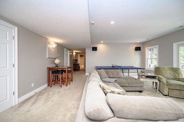 living room with baseboards, visible vents, light colored carpet, and recessed lighting