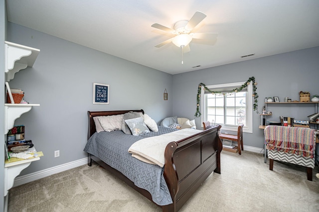 bedroom with baseboards, visible vents, light carpet, and ceiling fan