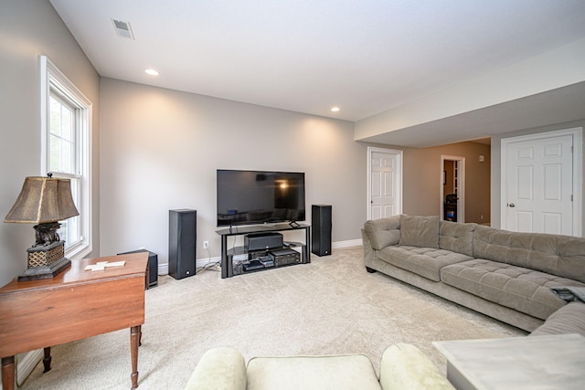 living area featuring baseboards, recessed lighting, visible vents, and light colored carpet